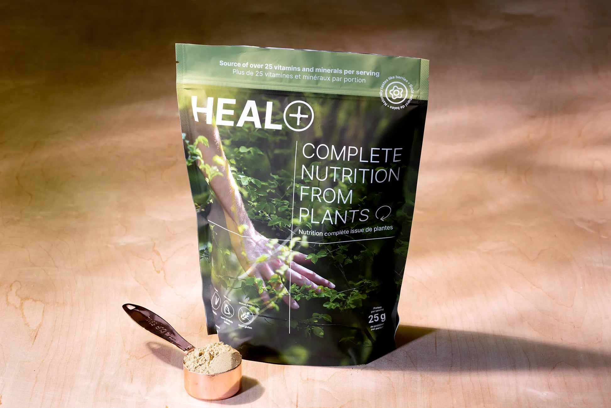 A bag of HEAL and a measuring spoon filled with the powder.