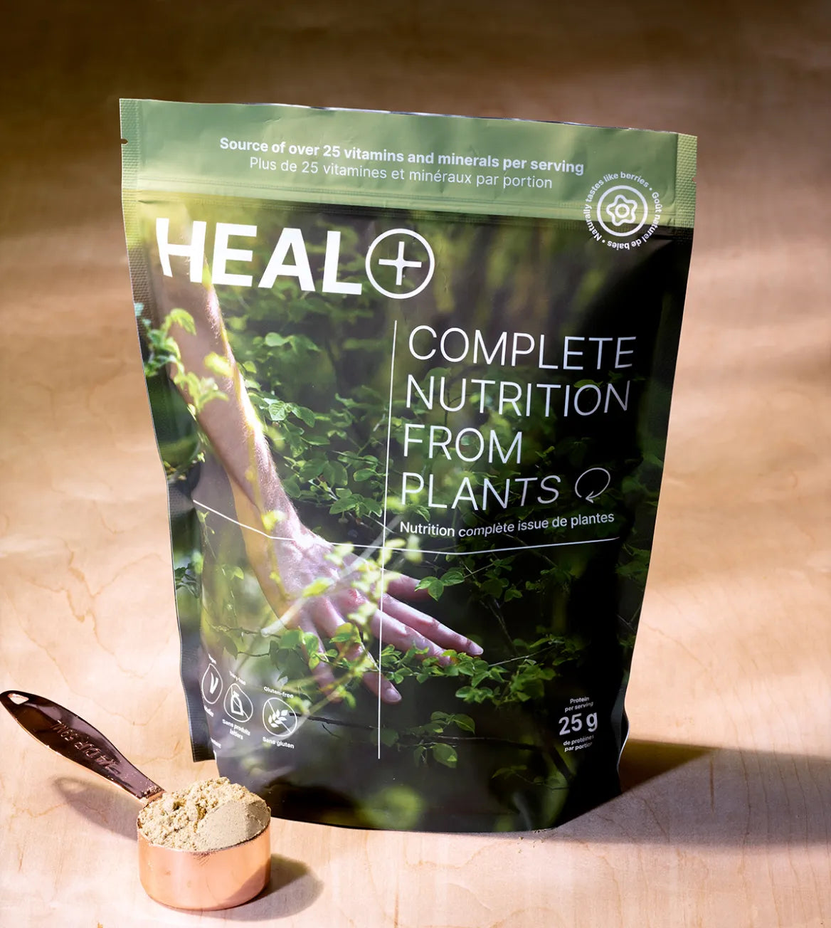 A close up of the HEAL bag and measuring spoon filled with the powder.